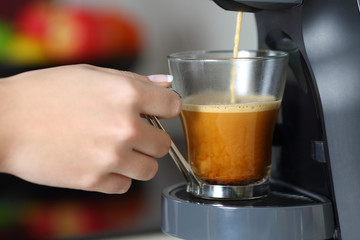 Woman hand using a coffee maker
