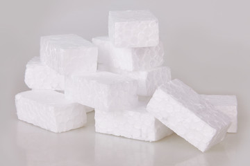 Filler packing background. Packaging foam pellets texture, top view, close-up. Polystyrene, white...