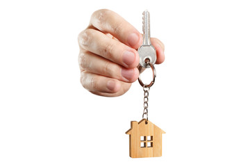 Hand holding a house key, isolated on white background