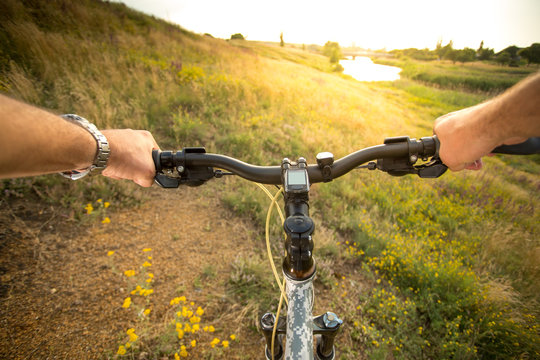 Mountain Bike. Bike Handle Bar With Lake And Sunshine In The Background