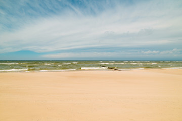 Endless beach scene, calm summer landscape of nature. Blue sky and soft ocean waves. White sand on the seashore