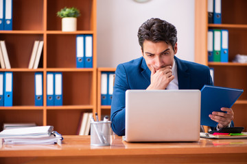 Young handsome businessman working in the office