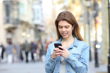 Happy teen texting messages on phone