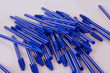 Blue plastic pens isolated on white