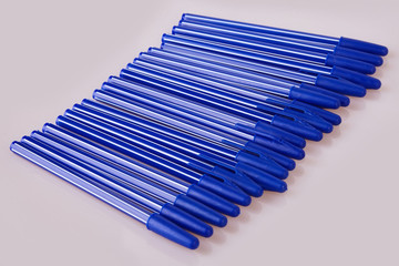 Blue plastic pens isolated on white