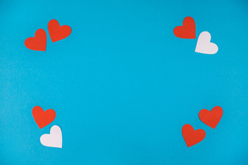 Red and white hearts on blue background.