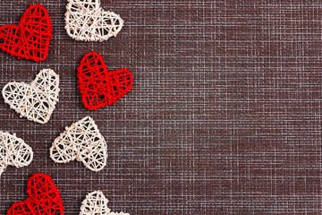Border of  decorative hearts on sackcloth background. Space for text. Valentine's day concept.