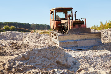 Sand quarry. Bulldozer working on sand dunes. Pure lake sand.  Old sand mining.