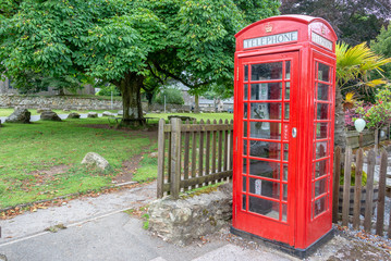Red traditional english Phone booth in Widecombe in the Moor, Devon, UK