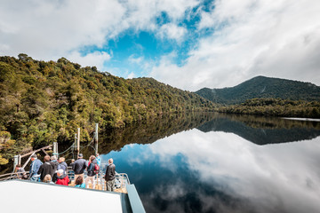 Tasmania, Australia on an Idyllic morning on the Gordon River, we'll take a cruise with great scenery and beautiful reflections in the water near the town of Strahan, on board of a highspeed catamaran