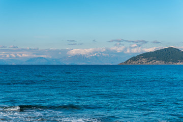 Fototapeta na wymiar Distant Snow Capped Mountains along the Southern Italian Mediterranean Coast