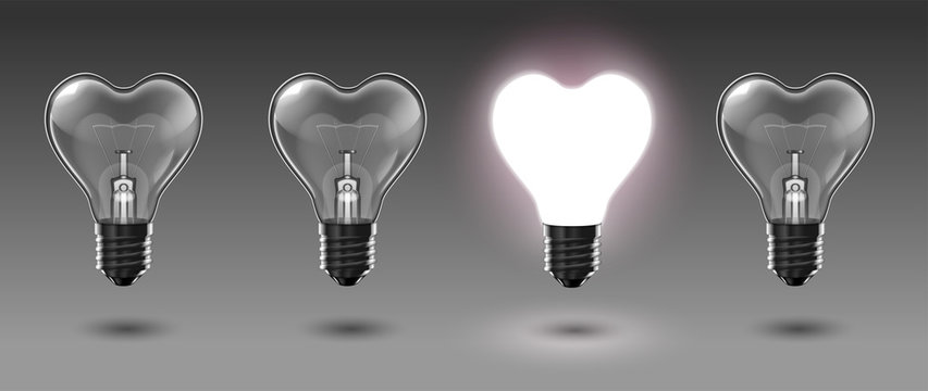 Four transparent heart-shaped bulbs, one of which glows with white light. Highly realistic illustration.