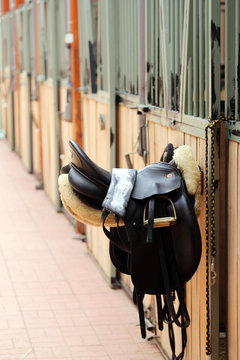 Photo of a beautiful leather sport saddle on equestrian competition