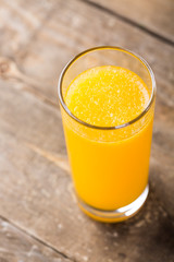 Orange juice in a glass on wooden table