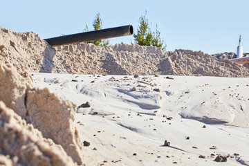Sand quarry. Bulldozer working on sand dunes. Pure lake sand.  Old sand mining.