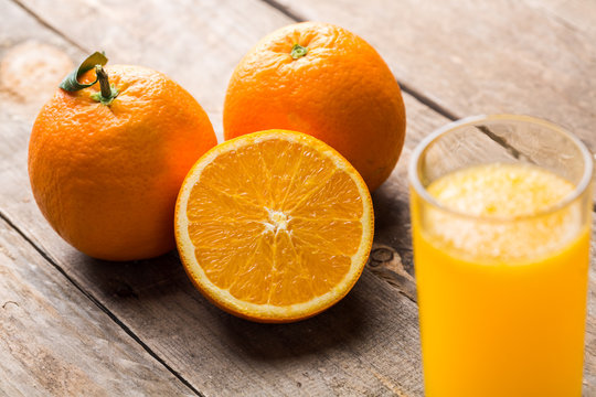 Orange juice and orange slices on wooden table © ddukang