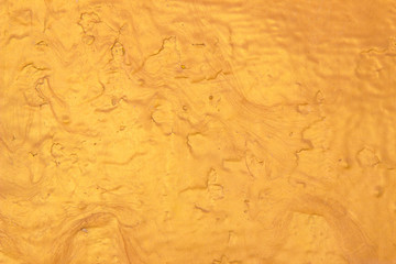 Abstract Gold polished metal brushed background or Shiny yellow leaf gold steel texture. Brushed metal plate with reflected light golden.