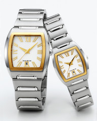 couple of gold and steel wristwatches