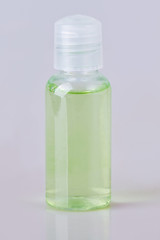 Hotel green bathroom shampoo, shower gel, lotion in a small transparent bottle isolated on a white background. Toiletries, 30 ml. Miniature shampoo bottle