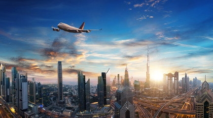Commercial jet plane flying above Dubai city