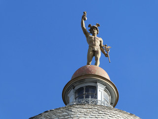 Obraz premium Statue of Mercury/Hermes at the top of the dome of old building in Novi Sad, Serbia