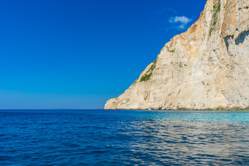 Fototapeta na wymiar Greece, Zakynthos, Huge white cliff and beautiful blue ocean water at island coast