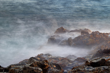 Waves break into shore.