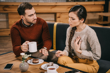 attractive woman talking with boyfriend in cafe