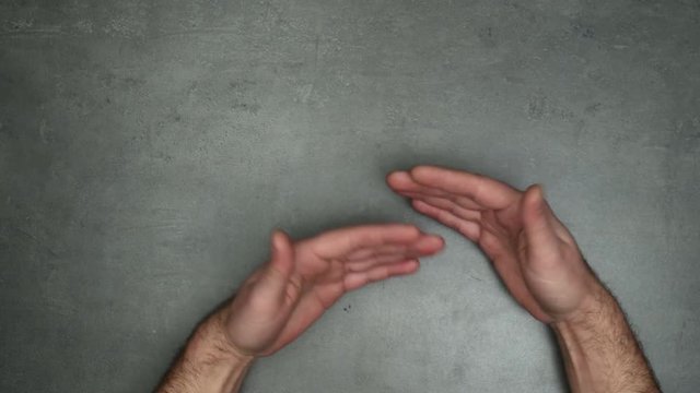 Hands gestures concept. Stop motion animation, 4K top view shot on male hands doing different gestures.