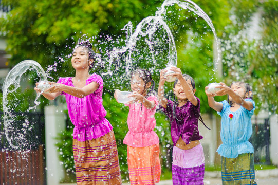 Thai Girls Children Playing Water In Songkran Festival With Thai Period Dress