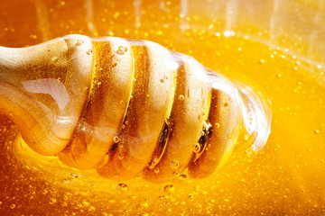 Honey with gold color flows down from a spoon. Healthy food concept. Healthy eating. Diet. Selective focus.