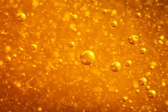 Abstract macro honey bubbles closeup in bright amber color. The texture of the honey. Healthy food concept. Diet. Selective focus.