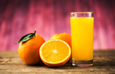 Orange juice and fresh oranges