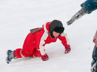 Winter fun. children ride from a snow hill.