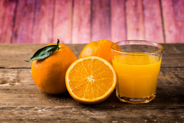 Orange juice and fresh oranges