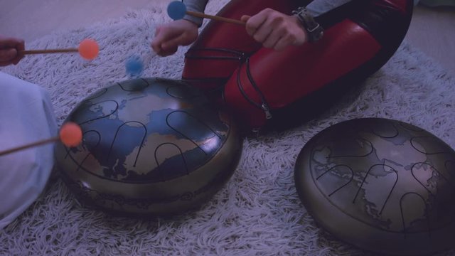 Young womеn playing the happy drum at home. 