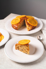 a homemade dessert, decorated with slice of orange, on a white plate