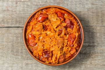 Braised cabbage with meat and smoked sausage. Traditional Polish and Lithuanian dishes. The view from the top. Copy-space.