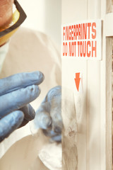Place of crime - collecting of dactyloscopy fingerprint evidence on surface of door