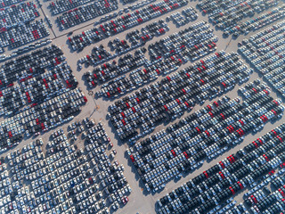 Aerial view car park at sea port or manufacture waiting for logistics ,shipping or export to worldwide.