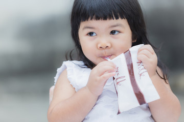 Adorable girl smiling and drink a milk for healthy.
