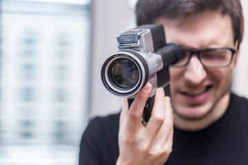 Filmmaker is doing a movie, vintage old movie camera