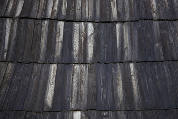 Old black wooden background. Grunge board. Dark Wood Pattern Background Texture. Roof scale wooden tiles