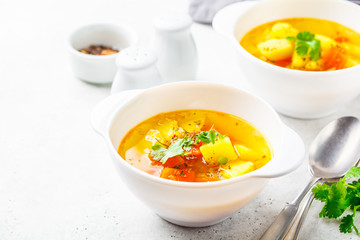 Vegetarian vegetable soup in bowls of white, white background.