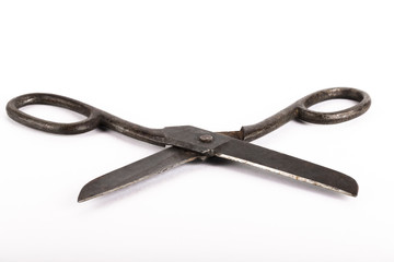 Old metal scissors on a light background