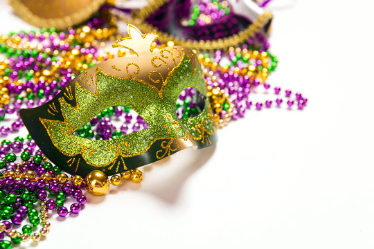 Festive Carnival mask and beads on a white background.