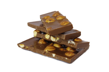 Chocolate pieces with hazelnuts isolated on white background. Hazelnut chocolate bar pieces tower 
