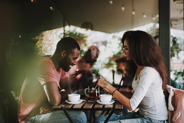 Female and male couuple drinking tea in cafe