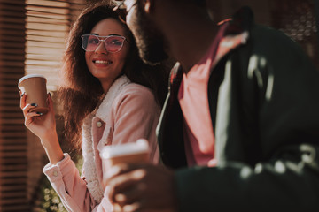 Close up of smiling beloved couple drink coffee
