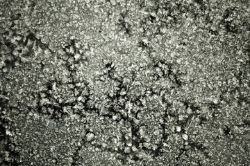 Frost on a cast iron surface. First slight frosts. Shallow depth of field. Selective focus. Toned